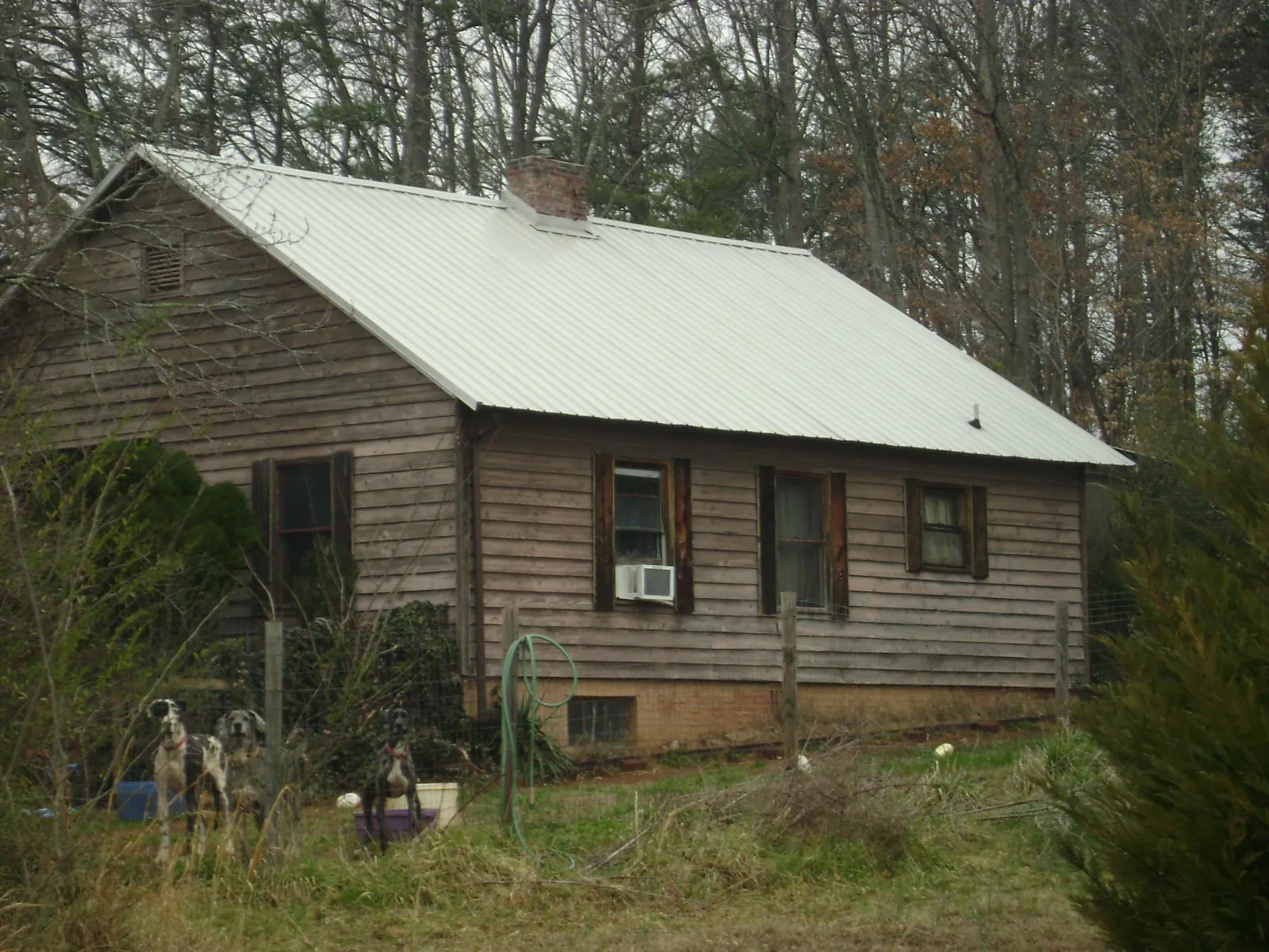 White metal roof on an old wood sided farmhouse, from a Metal Roof Installation job in Central Village